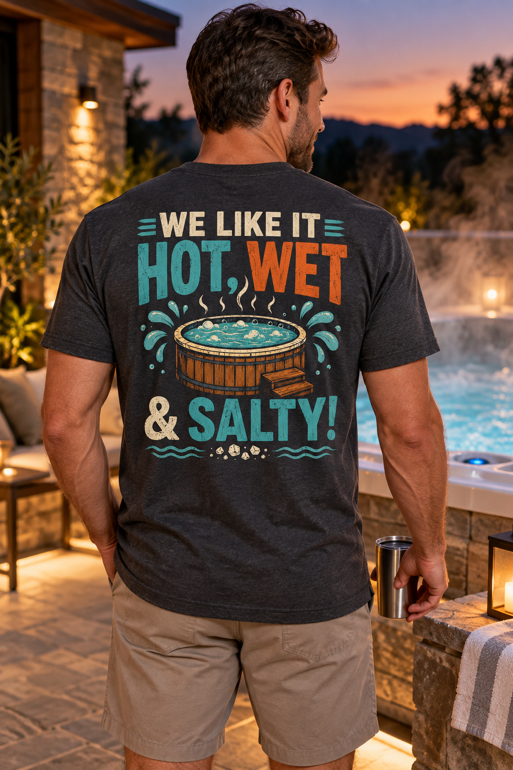 Model wearing We Like It Hot, Wet & Salty hot tub T-shirt beside a luxury spa