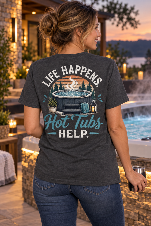 Model wearing Life Happens. Hot Tubs Help. hot tub T-shirt beside a luxury spa