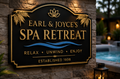 Personalized black and gold Spa Retreat sign displayed beside a luxury hot tub