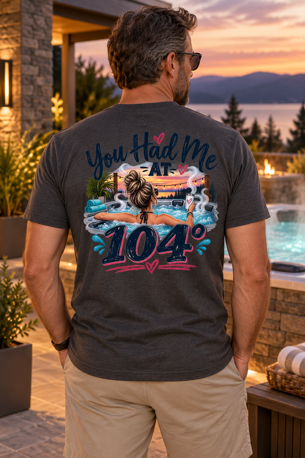 Model wearing You Had Me at 104° hot tub T-shirt beside a luxury spa